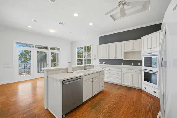 a kitchen with a sink stove and cabinets