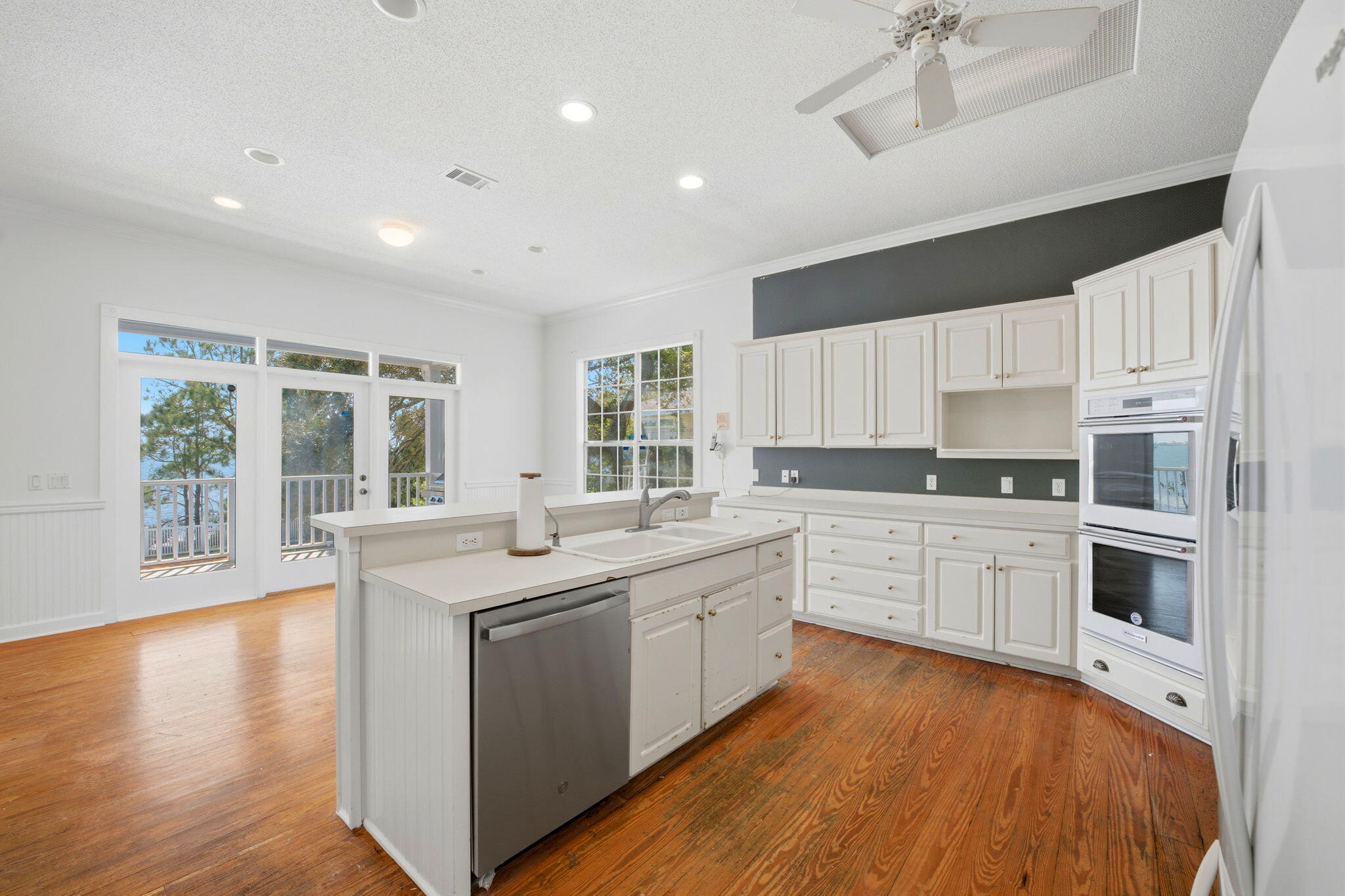 8127 Pompano Street Navarre, FL 32566 - Photo 14 of 44 a kitchen with a sink stove and cabinets