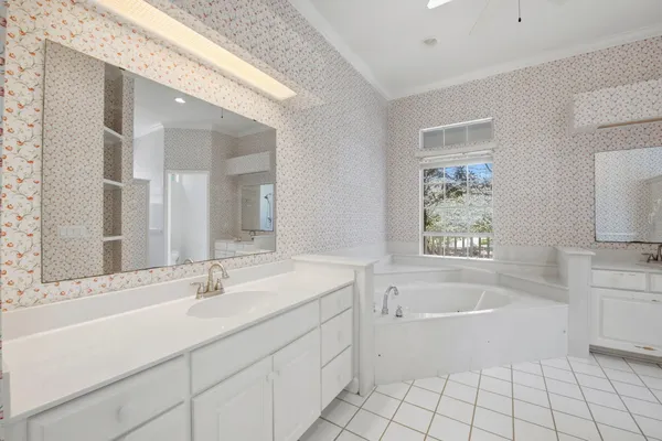 a bathroom with a sink mirror and a bathtub
