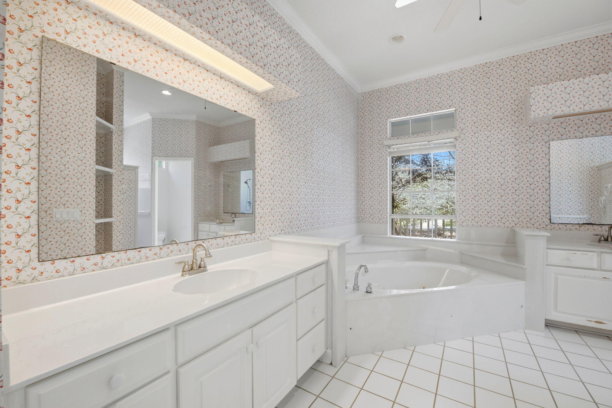8127 Pompano Street Navarre, FL 32566 - Photo 18 of 44 a bathroom with a sink mirror and a bathtub
