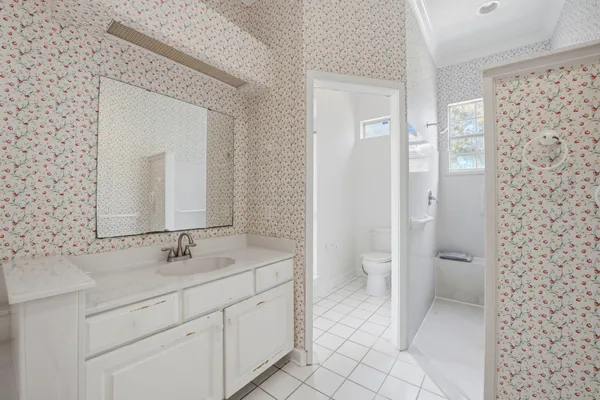 a bathroom with a double vanity sink mirror and toilet