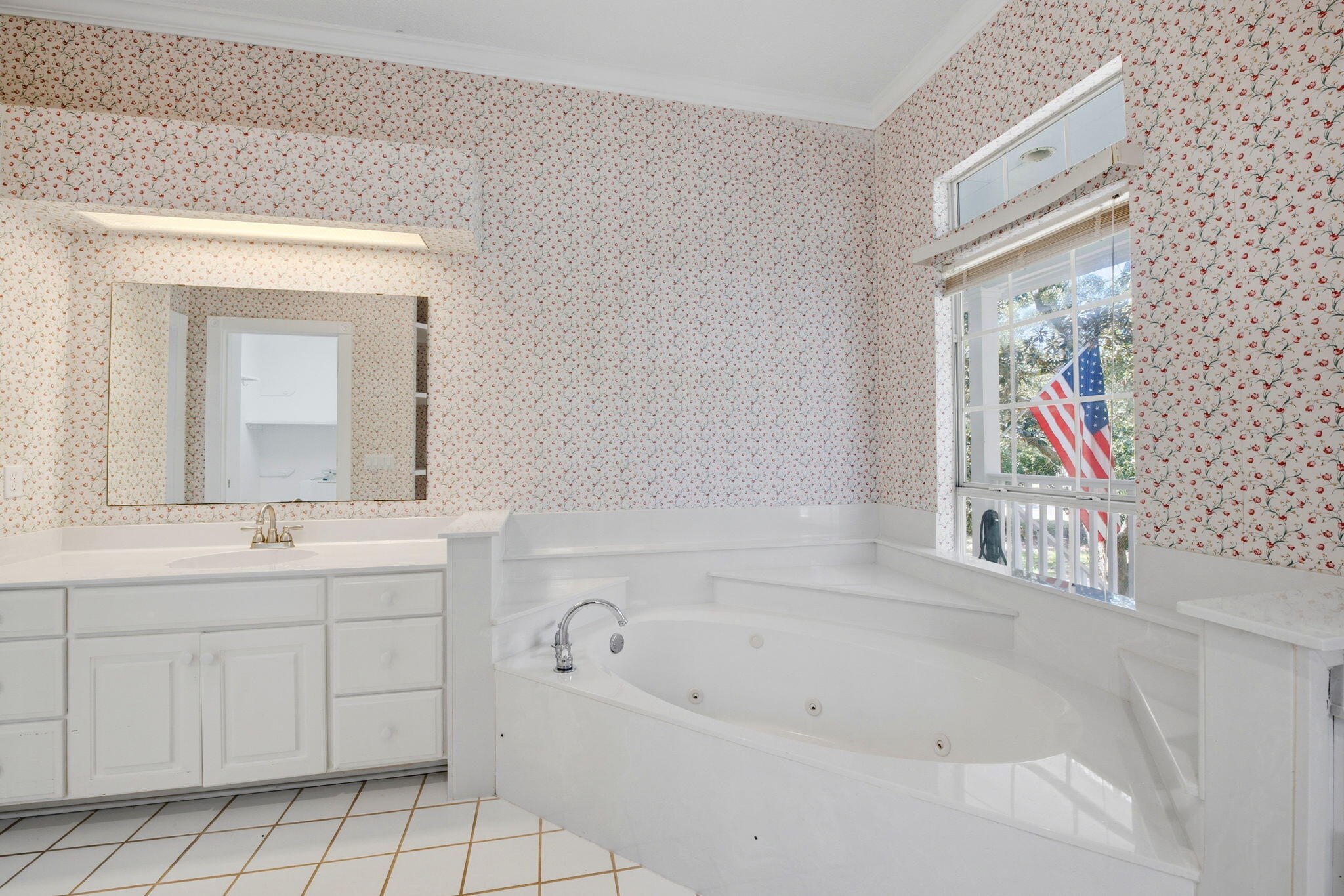 8127 Pompano Street Navarre, FL 32566 - Photo 20 of 44 a bathroom with a bathtub sink and mirror