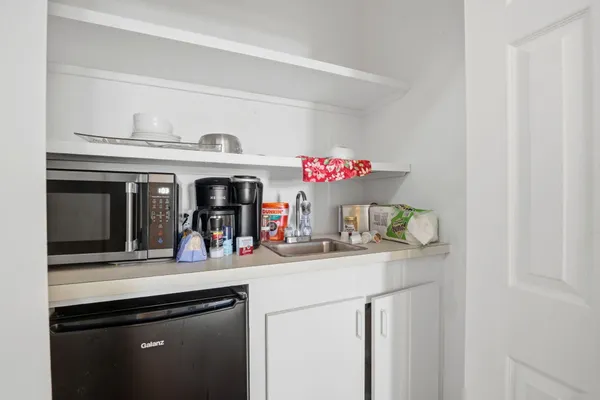 a kitchen with a sink and a mirror