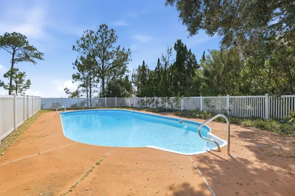 a view of a swimming pool with a lounge chair
