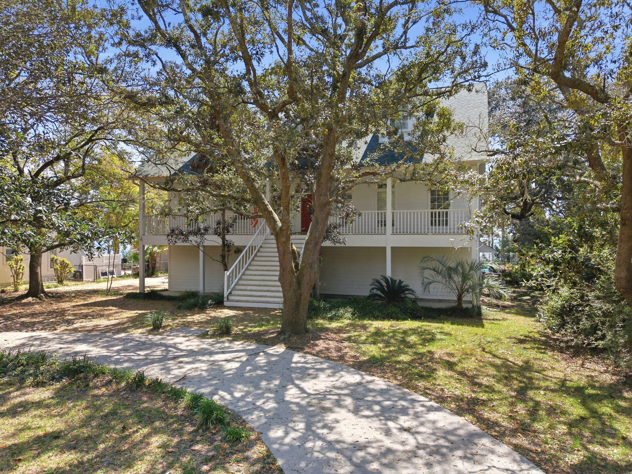 8127 Pompano Street Navarre, FL 32566 - Photo 4 of 44 a view of a house with a yard