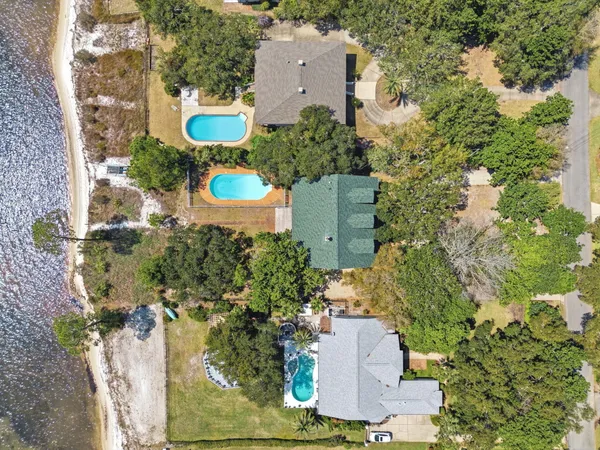 an aerial view of a house with a yard and garden