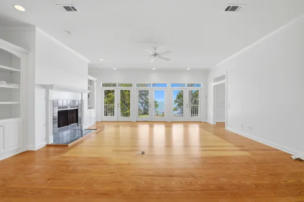 a view of an empty room with a fireplace and a window