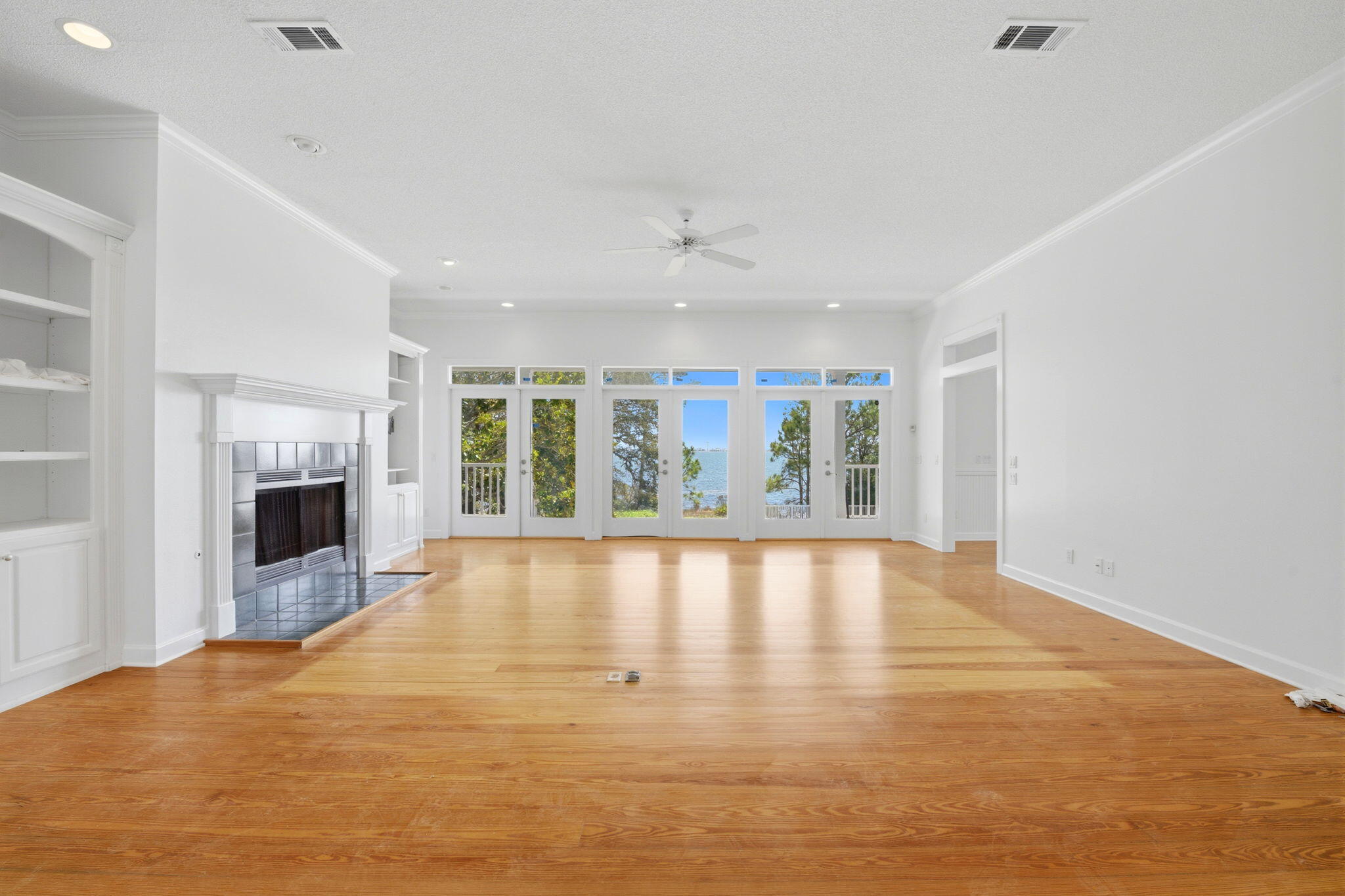 8127 Pompano Street Navarre, FL 32566 - Photo 9 of 44 a view of an empty room with a fireplace and a window