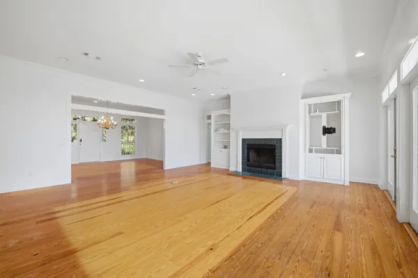 a view of an empty room with a fireplace and a window