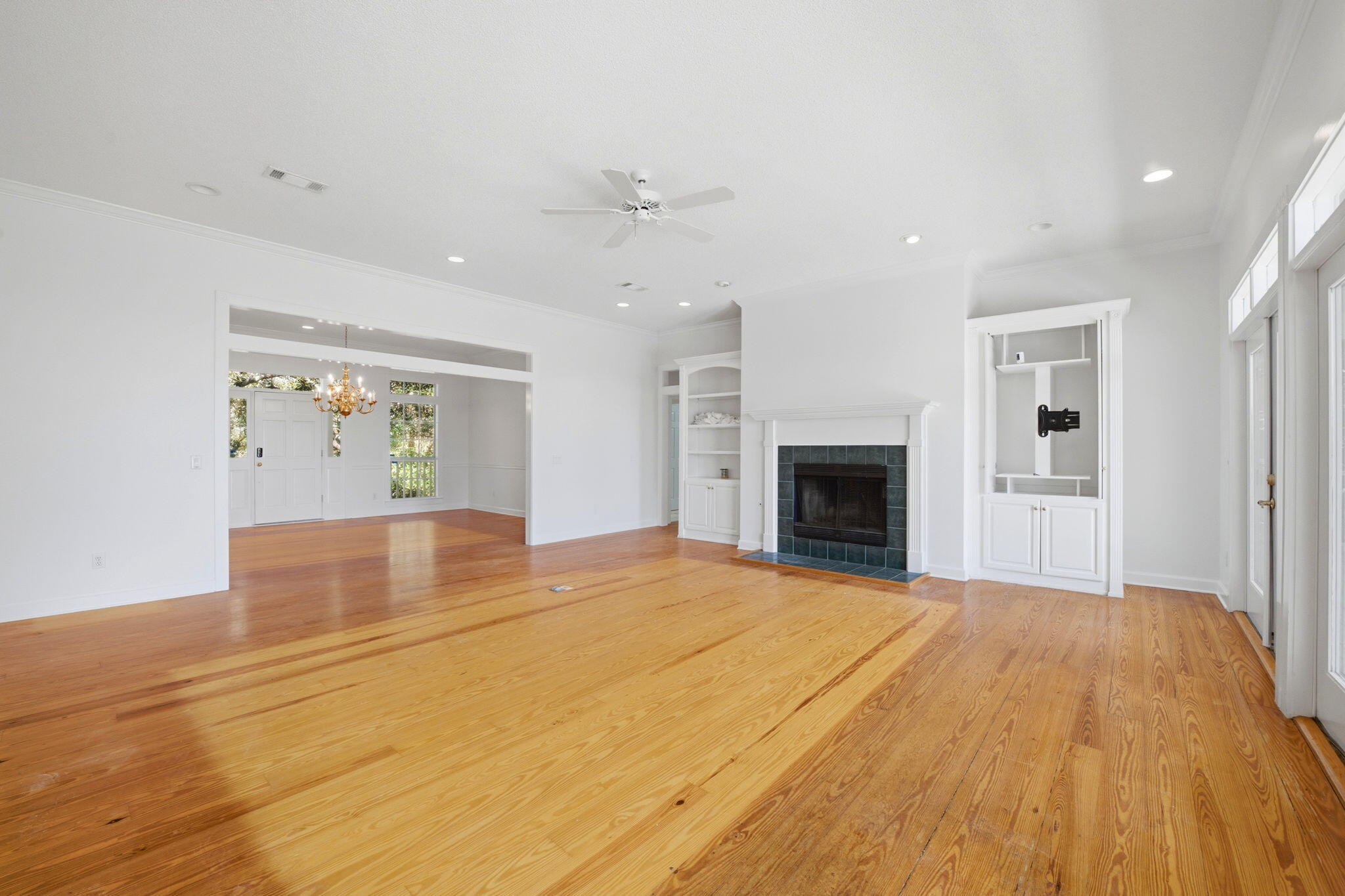 8127 Pompano Street Navarre, FL 32566 - Photo 10 of 44 a view of an empty room with a fireplace and a window