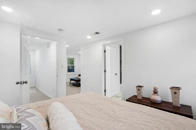 a bedroom with a bed and a large mirror