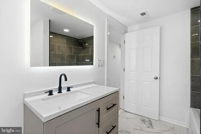a bathroom with a sink and a mirror