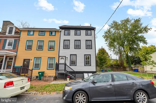 a front view of a house with parking space