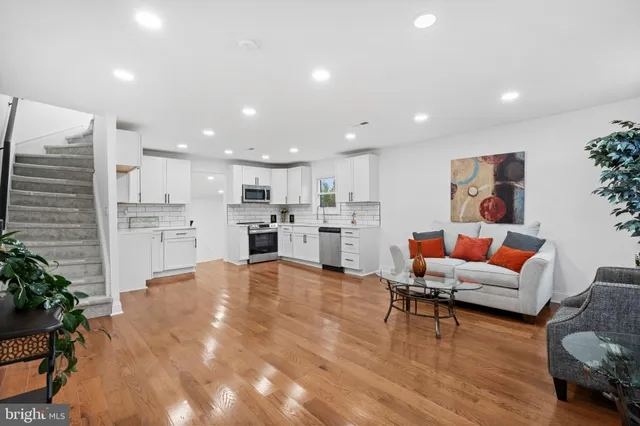 a living room with furniture and kitchen view