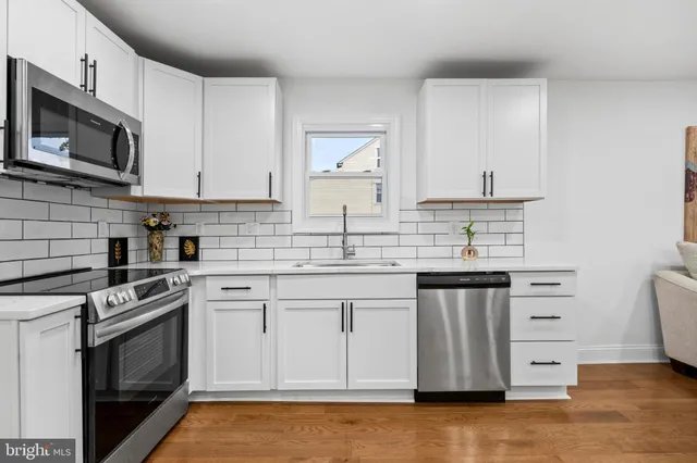 a kitchen with stainless steel appliances a stove microwave and cabinets