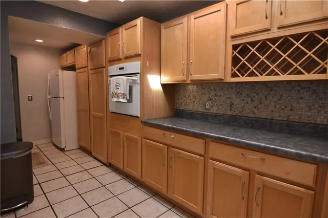 a kitchen with stainless steel appliances a refrigerator and cabinets