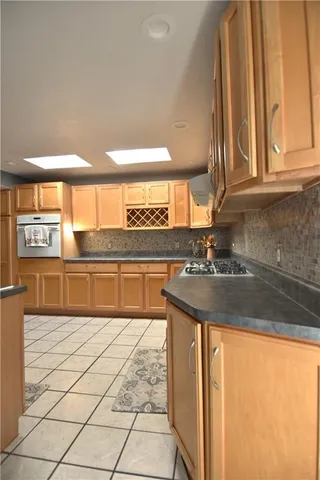 a kitchen with stainless steel appliances granite countertop a sink and a white cabinets