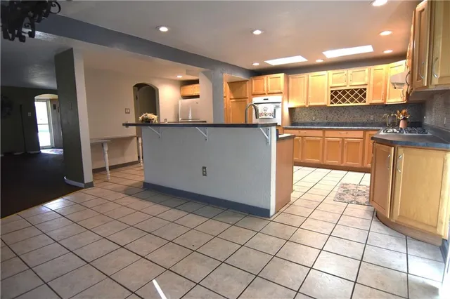 a kitchen with stainless steel appliances a sink and cabinets