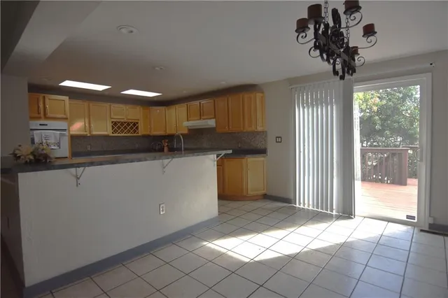 a kitchen with stainless steel appliances granite countertop a sink a stove a refrigerator and cabinets