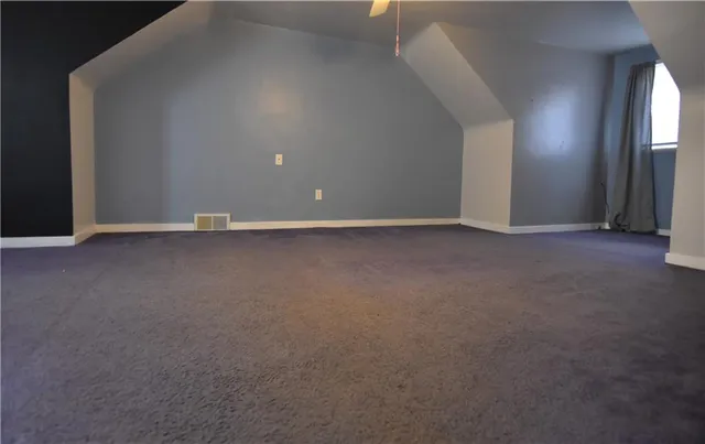 a view of a room with a ceiling fan and chandelier fan