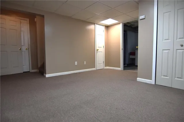 an empty room with windows and mirror