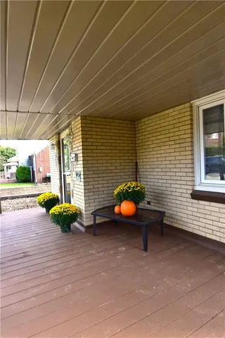 a view of a patio with couple of chairs and a fire pit