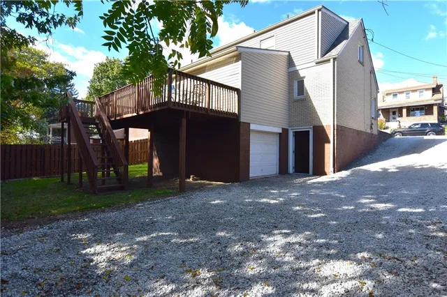 a view of a backyard with a small cabin and wooden chair