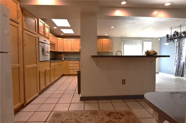 a kitchen with stainless steel appliances a sink a stove and cabinets