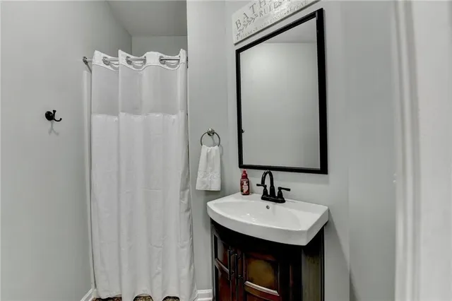 a kitchen with kitchen island granite countertop a stove a refrigerator and a center island with wooden floor