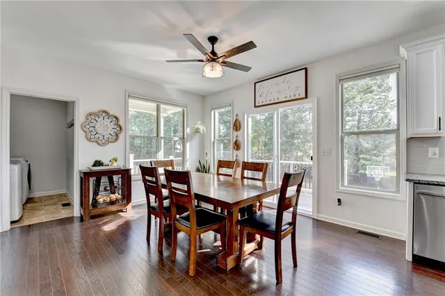 a living room with furniture a flat screen tv and a window