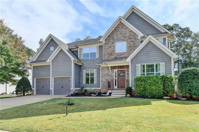 a view of a hallway with wooden floor and a window