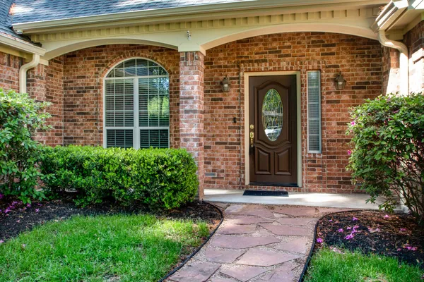 a front view of a house with garden
