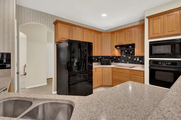 a kitchen with a refrigerator sink and stove