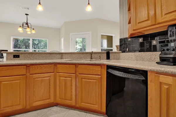 a kitchen with granite countertop cabinets stainless steel appliances and a counter space