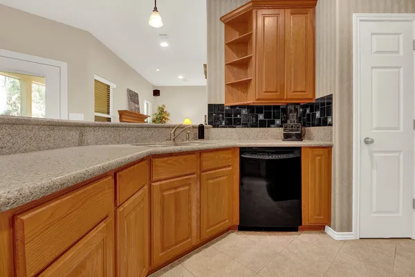 a kitchen with stainless steel appliances granite countertop a sink and a stove