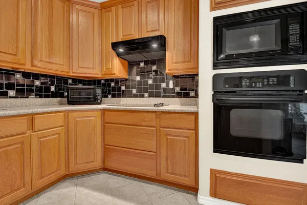 a kitchen with granite countertop white cabinets stainless steel appliances and sink