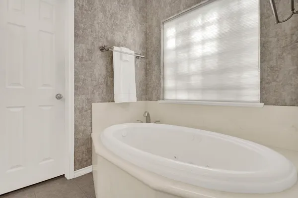 a white bath tub sitting next to a white sink