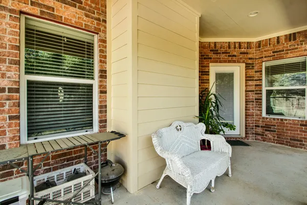 a view of a house with backyard and sitting area