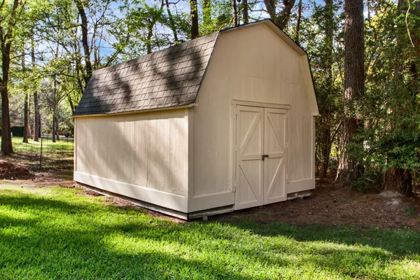 an aerial view of a house with a yard and garden