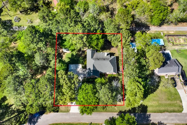an aerial view of a house with a yard and garden
