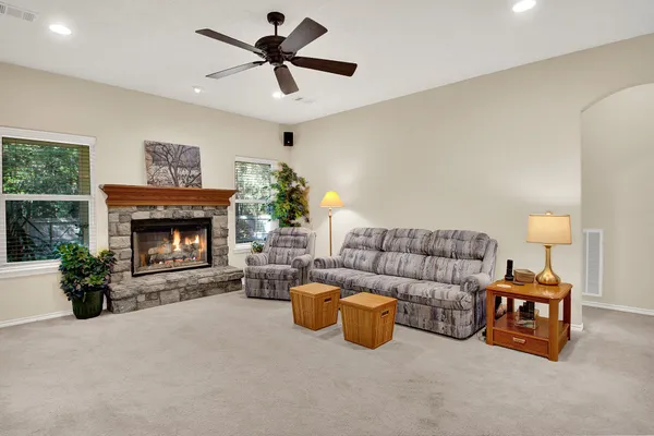 a living room with furniture and a fireplace