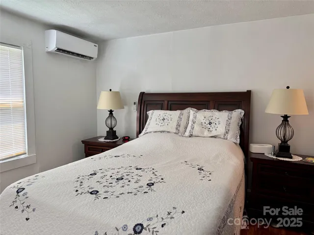 a bed sitting in a bedroom next to a window