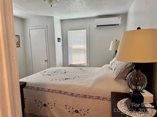 a bedroom with a bed and window