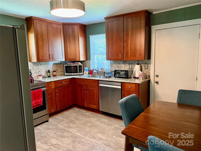 a kitchen with a sink appliances and cabinets