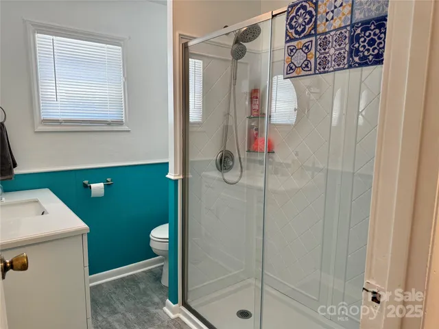 a bathroom with a shower and a sink