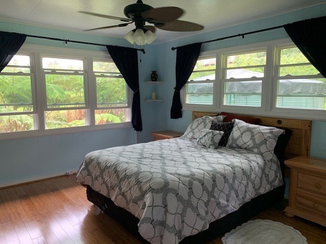 84-1180 Bruner Road Captain Cook, HI 96704 - Photo 8 of 28 a bed sitting in a bedroom next to a window