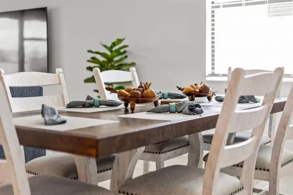 a dining room with furniture and wooden floor