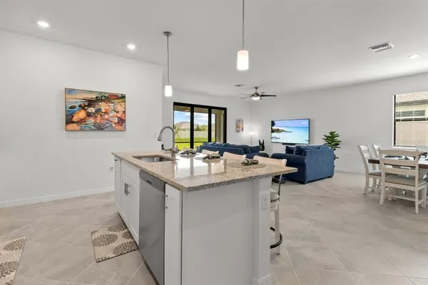 a kitchen with granite countertop a sink and a stove top oven