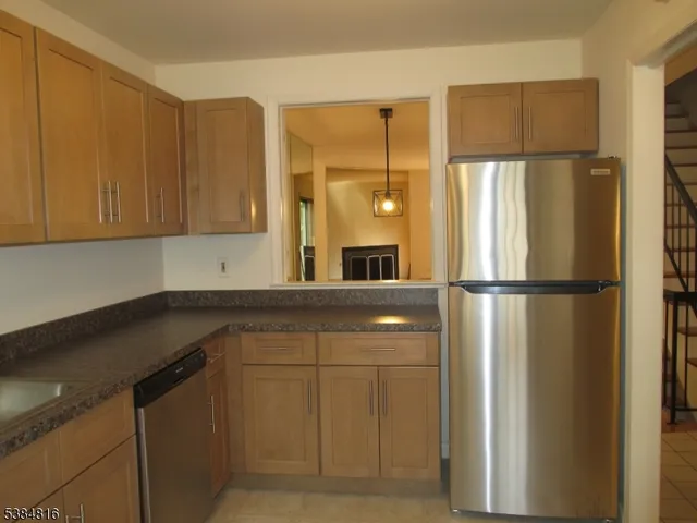 a kitchen with a refrigerator and cabinets