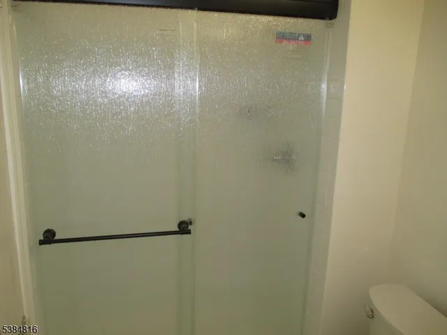 a bathroom with a glass shower door